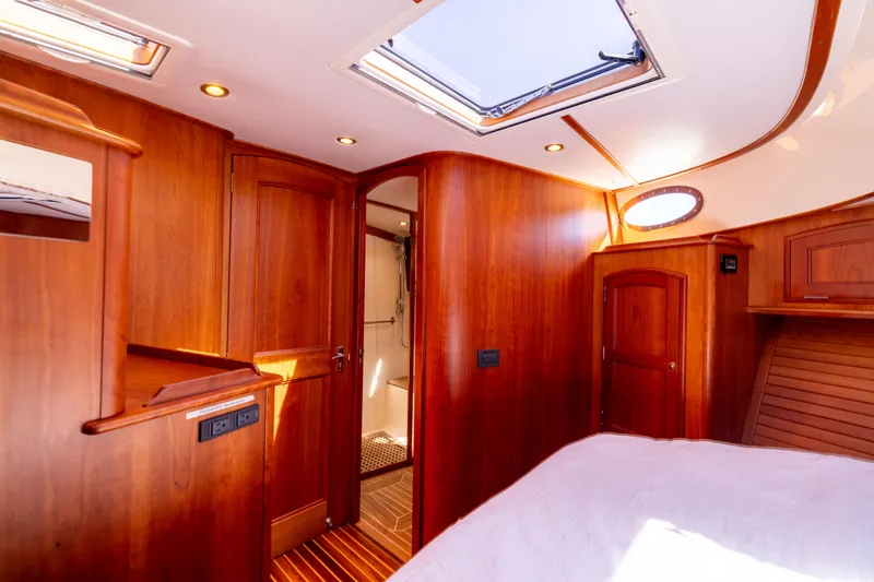 Slide: The Image of Luxurious 2014 Hinckley Talaria 48 Flybridge interior with elegant wood finish and skylight. - 44