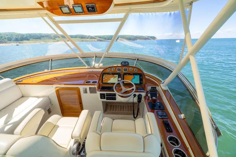 Slide: The Image of Helm of 2014 Hinckley Talaria 48 Flybridge yacht with ocean view. - 55