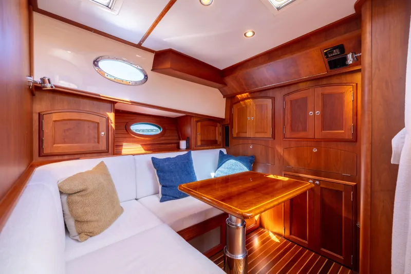 Slide: The Image of Luxurious interior of 2014 Hinckley Talaria 48 Flybridge with wood cabinetry and plush seating. - 37