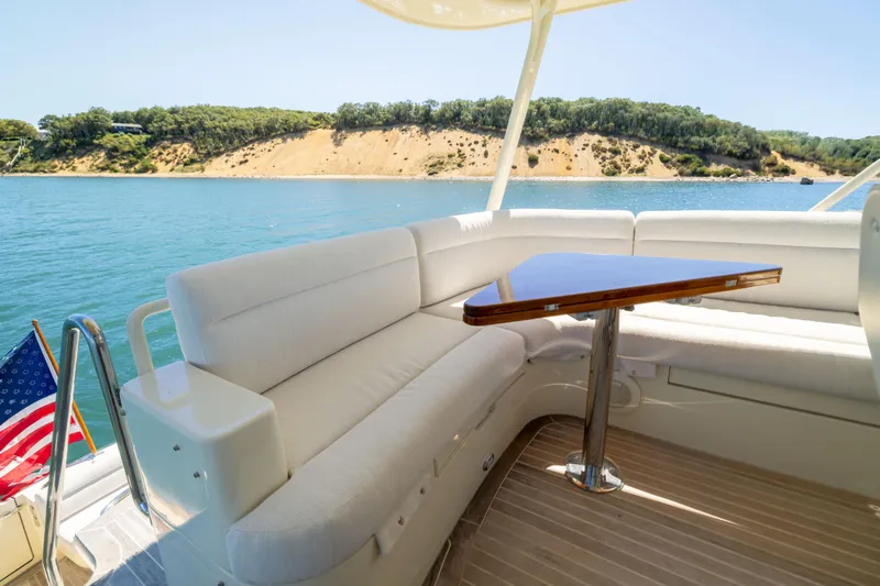 Slide: The Image of Luxurious 2014 Hinckley Talaria 48 Flybridge yacht with elegant seating and scenic water view. - 66