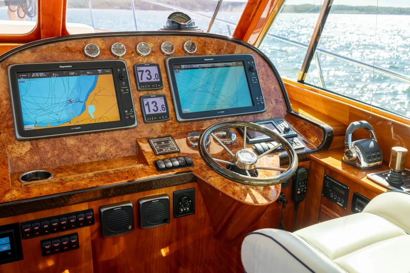 Slide: The Image of Helm of 2014 Hinckley Talaria 48 Flybridge with navigation screens and controls. - 27