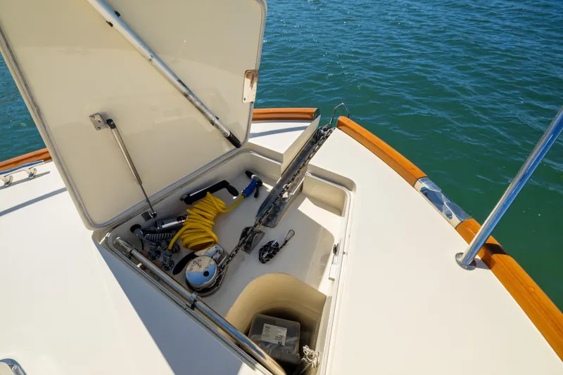 Slide: The Image of Open storage compartment on 2014 Hinckley Talaria 48 Flybridge yacht, with marine equipment visible. - 71
