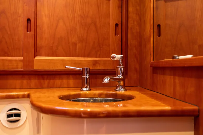 Slide: The Image of Wooden bathroom vanity with sink on 2014 Hinckley Talaria 48 Flybridge yacht. - 40