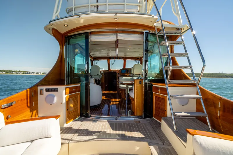 Slide: The Image of 2014 Hinckley Talaria 48 Flybridge yacht interior with elegant wood finish and open flybridge access. - 18