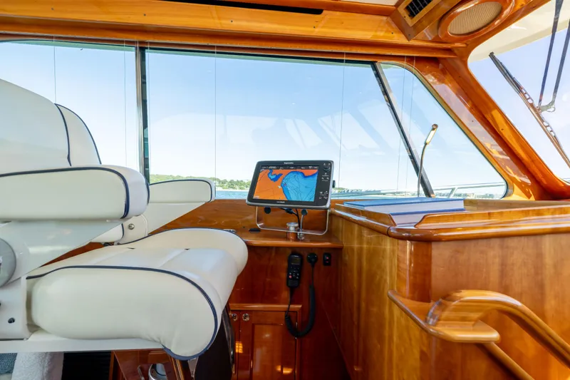 Slide: The Image of Luxurious helm of 2014 Hinckley Talaria 48 Flybridge with navigation display and plush seating. - 26