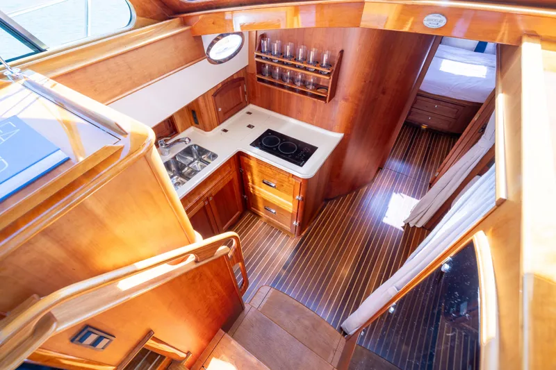 Slide: The Image of Luxurious interior of 2014 Hinckley Talaria 48 Flybridge yacht with wood finish and modern kitchen. - 31