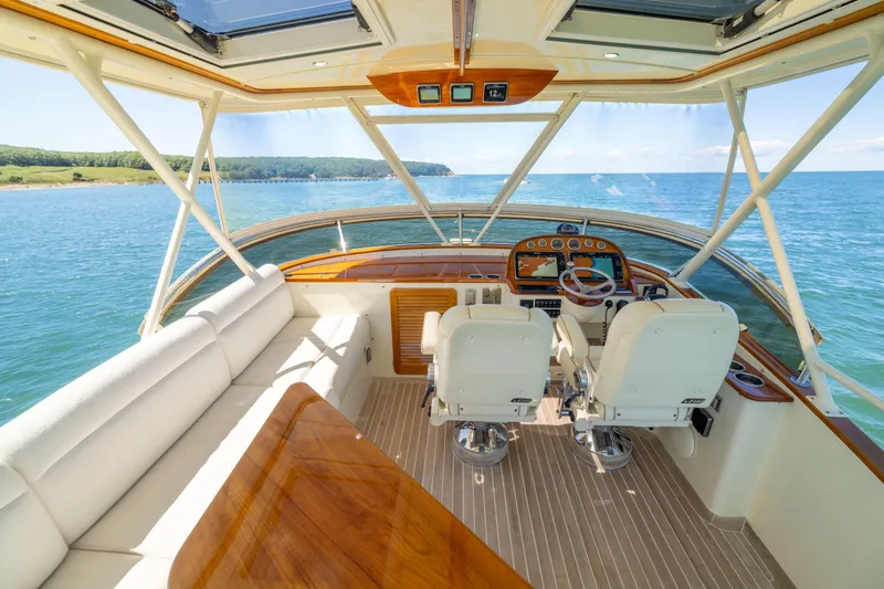 Slide: The Image of 2014 Hinckley Talaria 48 Flybridge interior with ocean view, featuring helm and seating area. - 53
