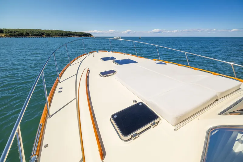 Slide: The Image of 2014 Hinckley Talaria 48 Flybridge yacht deck on open water, clear sky. - 72