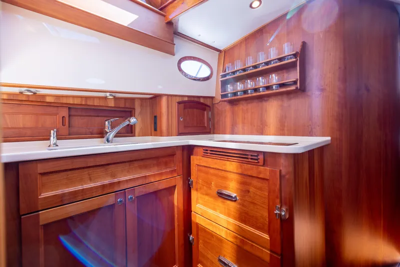 Slide: The Image of Luxurious wooden interior of 2014 Hinckley Talaria 48 Flybridge yacht kitchen. - 32