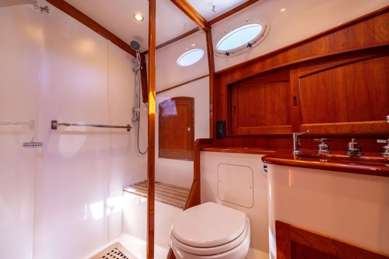 Slide: The Image of Luxurious 2014 Hinckley Talaria 48 Flybridge bathroom with wood accents and modern fixtures. - 45