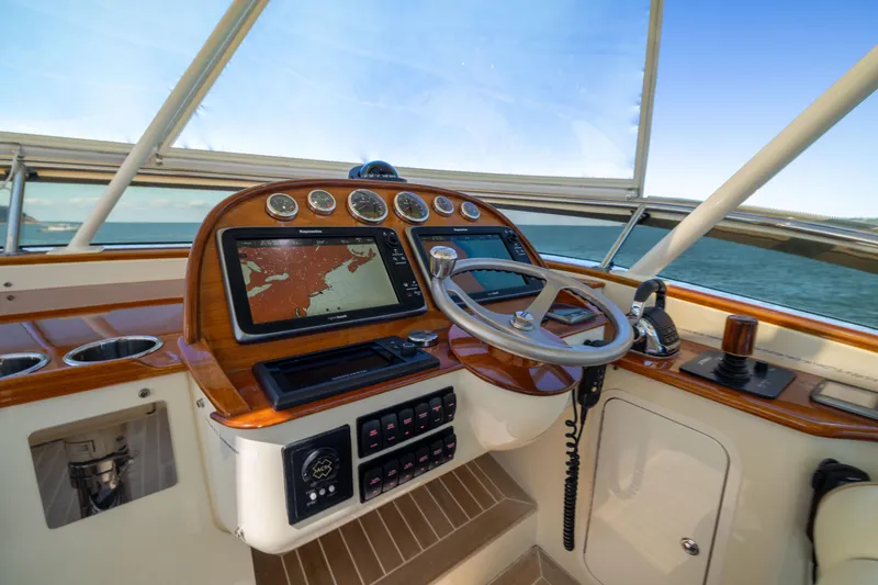 Slide: The Image of Helm of 2014 Hinckley Talaria 48 Flybridge with navigation system and controls. - 56