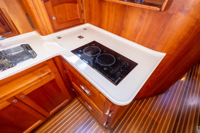 Slide: The Image of Hinckley Talaria 48 Flybridge 2014 yacht kitchen with stove and wooden cabinetry. - 36