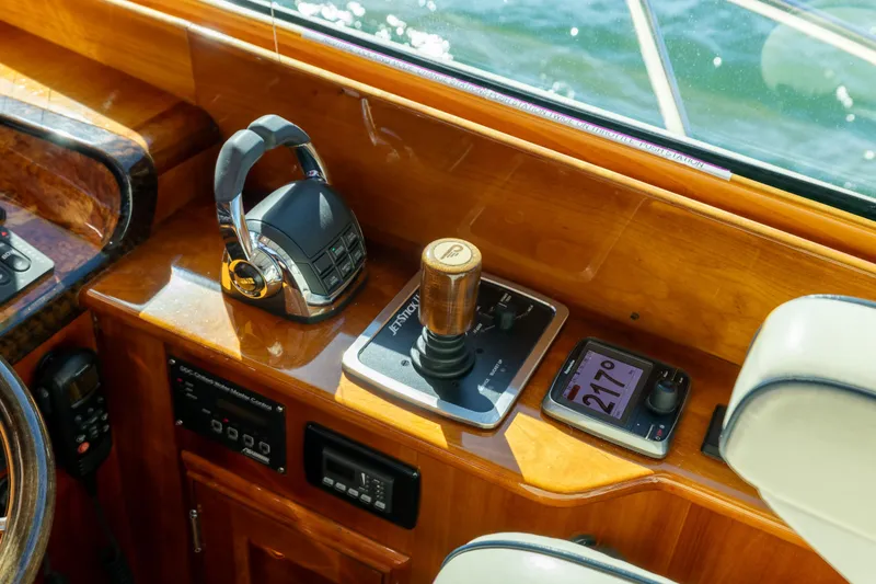 Slide: The Image of Helm controls of 2014 Hinckley Talaria 48 Flybridge with joystick and navigation display. - 28