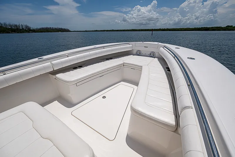 Slide: The Image of 2012 Regulator 28 Forward Seating boat with spacious white seating on calm water. - 11