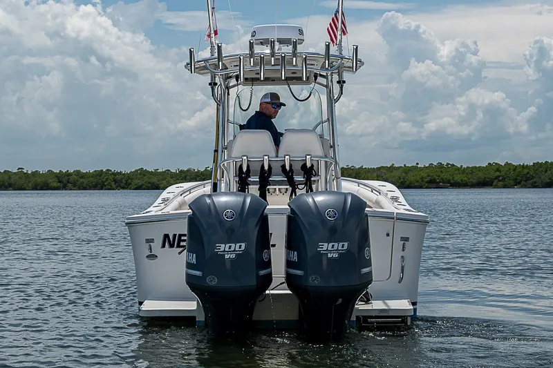 Slide: The Image of 2012 Regulator 28 Forward Seating boat with twin Yamaha 300 engines on water. - 4