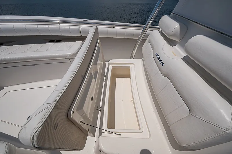 Slide: The Image of 2012 Regulator 28 Forward Seating boat with open storage compartment. - 16