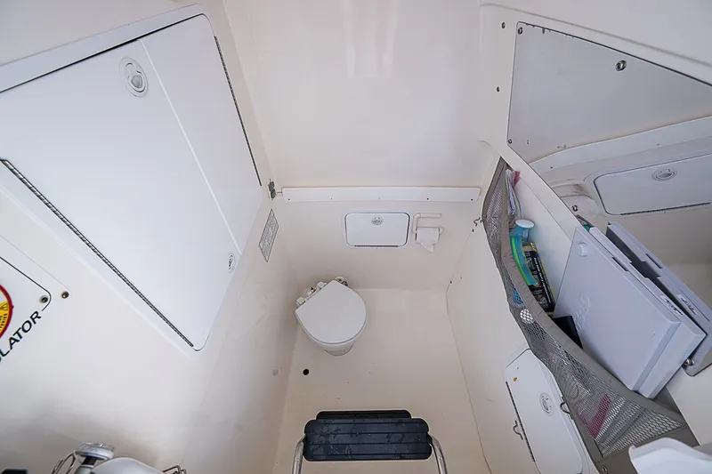 Slide: The Image of Interior of 2012 Regulator 28 Forward Seating boat with compact marine toilet. - 24