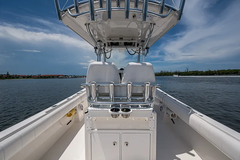 Slide: The Image of 2012 Regulator 28 Forward Seating boat on calm water under a clear sky. - 22