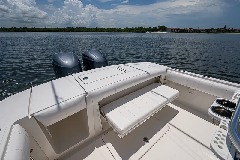 Slide: The Image of 2012 Regulator 28 Forward Seating boat with dual engines on a calm lake. - 19