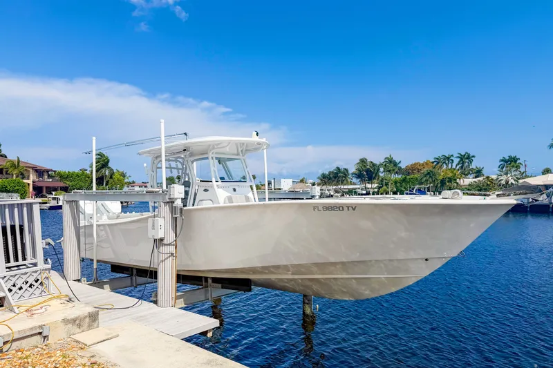 Slide: The Image of 2024 Cape Horn 34XS boat docked by a scenic waterfront under a clear blue sky. - 25