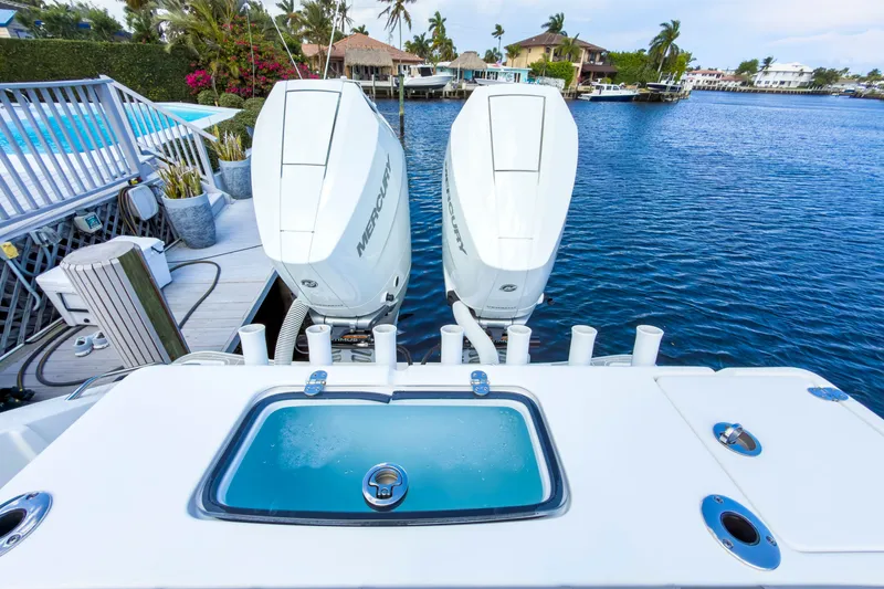 Slide: The Image of 2024 Cape Horn 34XS boat with dual Mercury engines docked by waterfront homes. - 20