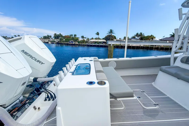 Slide: The Image of 2024 Cape Horn 34XS boat with Mercury engines, docked by a scenic waterfront. - 18