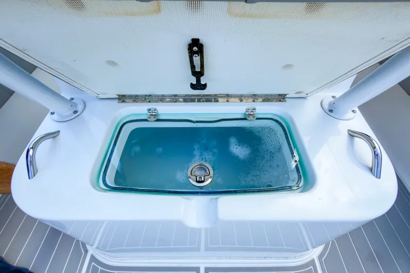 Slide: The Image of Livewell on 2024 Cape Horn 34XS boat, featuring stainless steel handles and secure latch. - 15