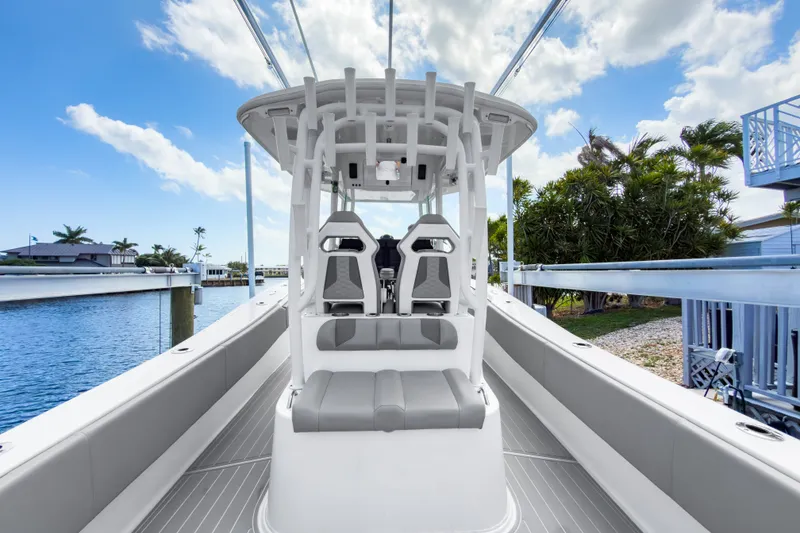 Slide: The Image of 2024 Cape Horn 34XS boat interior with seating, docked by water under blue sky. - 13