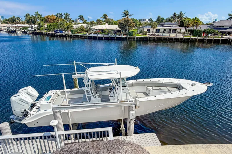 The Image of 2024 Cape Horn 34XS boat docked by waterfront homes, clear blue sky. - 0
