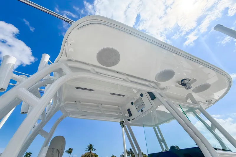 Slide: The Image of 2024 Cape Horn 34XS boat canopy with speakers, under a clear blue sky. - 24