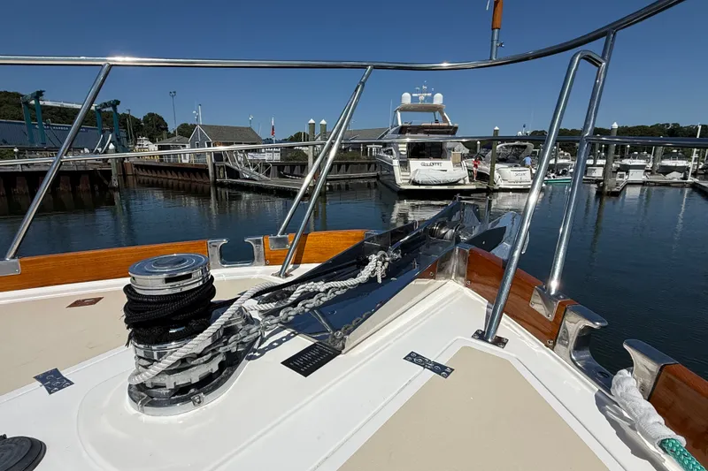 Slide: The Image of Bow view of 2003 Grand Banks 49 Eastbay HX yacht docked in a marina. - 16