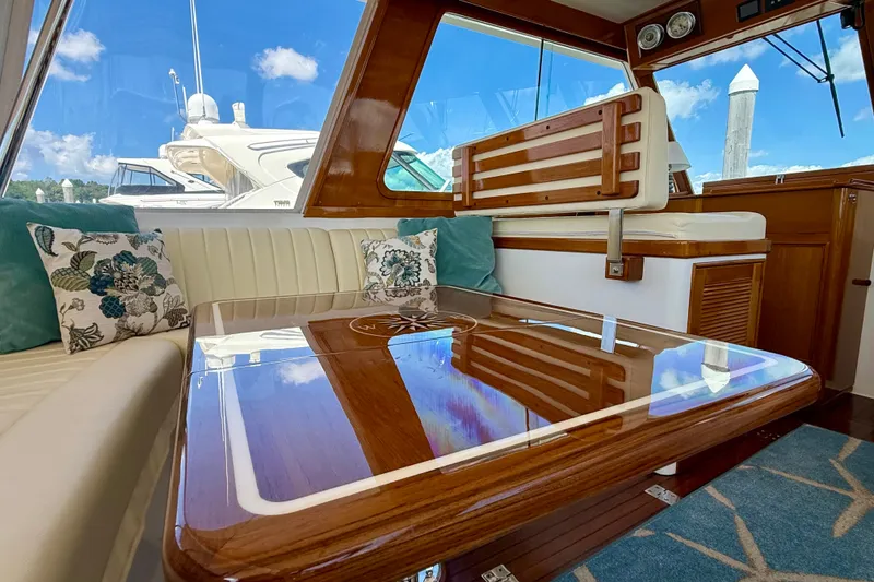 Slide: The Image of Luxurious interior of 2003 Grand Banks 49 Eastbay HX yacht with polished wood table. - 43