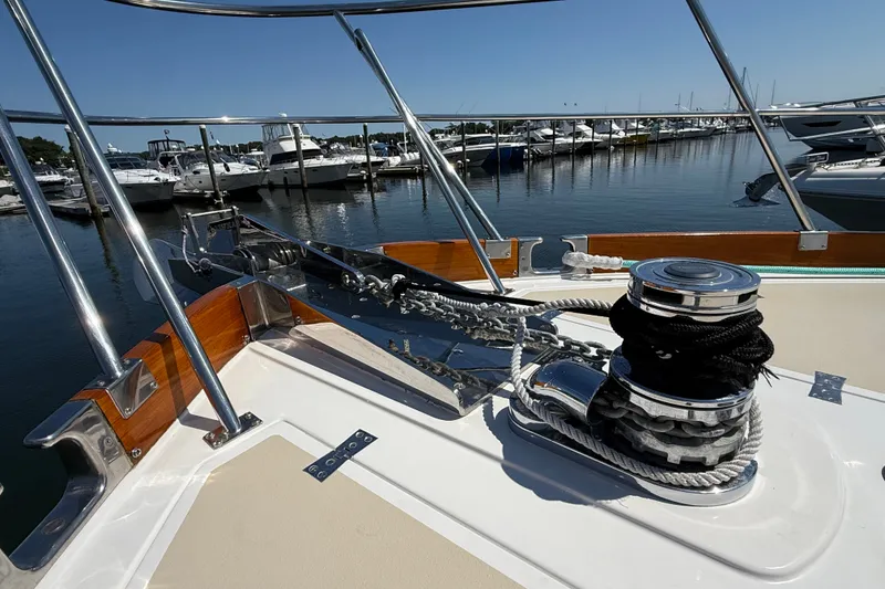 Slide: The Image of 2003 Grand Banks 49 Eastbay HX yacht deck with anchor winch at marina. - 15