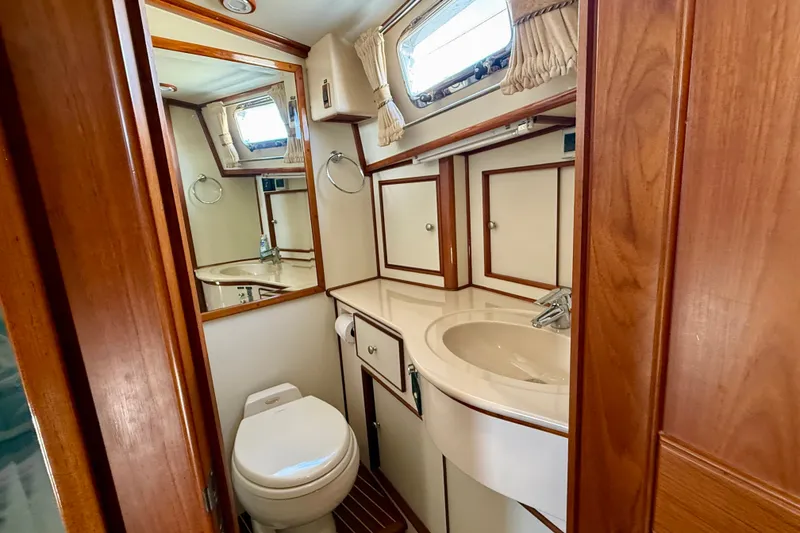 Slide: The Image of Luxurious 2003 Grand Banks 49 Eastbay HX yacht bathroom with wood accents and modern fixtures. - 67