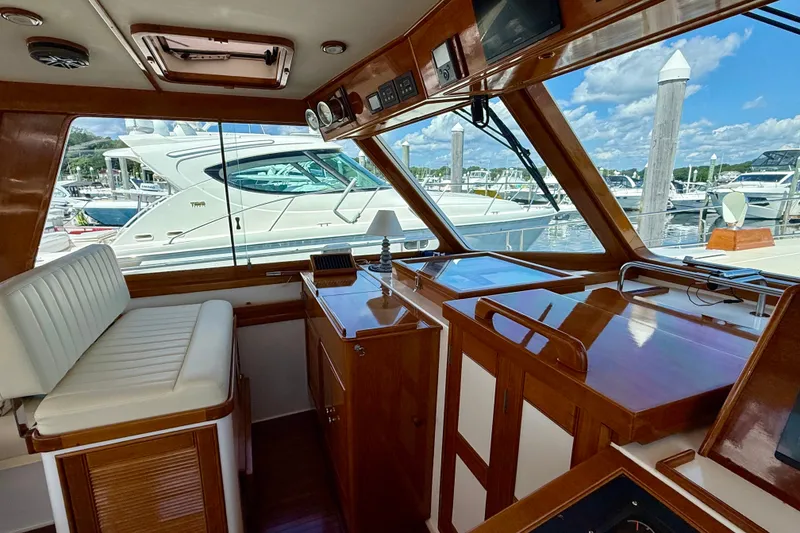 Slide: The Image of Interior of 2003 Grand Banks 49 Eastbay HX yacht with wood finish and marina view. - 41