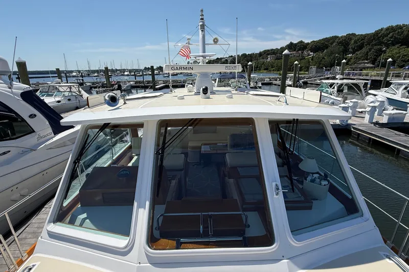 Slide: The Image of 2003 Grand Banks 49 Eastbay HX yacht docked at a marina, sunny day. - 21