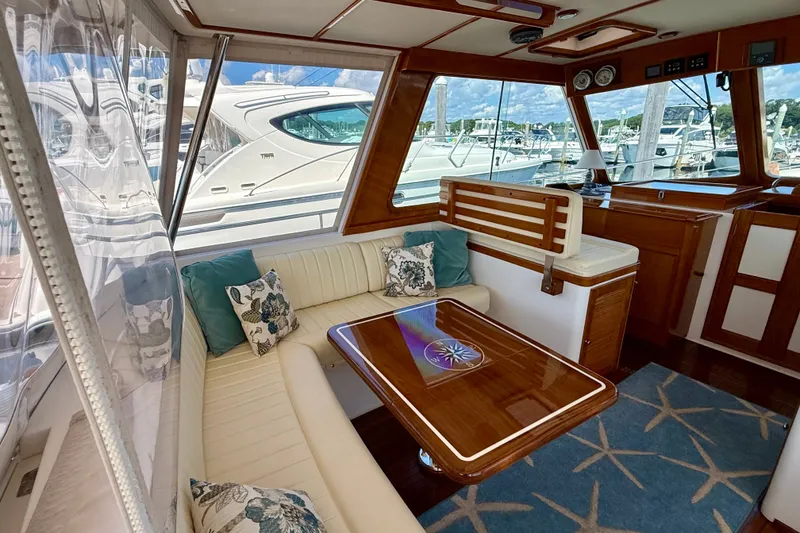 Slide: The Image of Luxurious interior of 2003 Grand Banks 49 Eastbay HX yacht with elegant seating and wooden accents. - 36