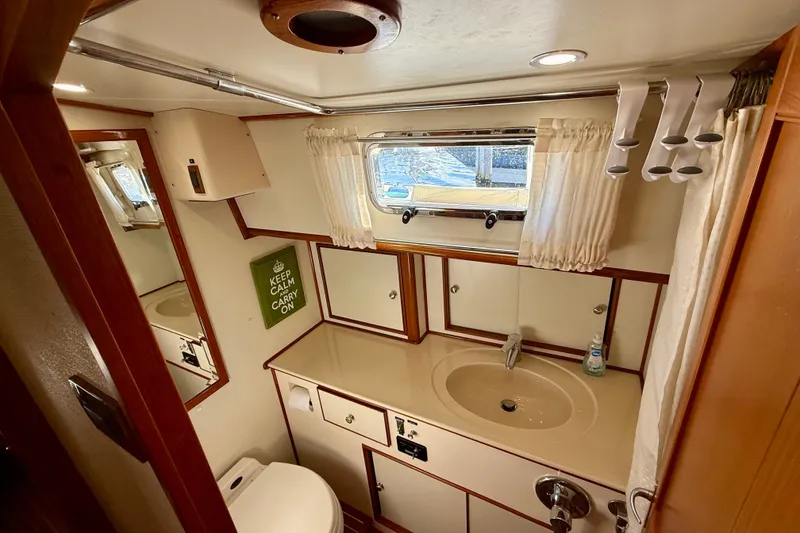 Slide: The Image of Bathroom interior of 2003 Grand Banks 49 Eastbay HX yacht, featuring sink and window. - 56