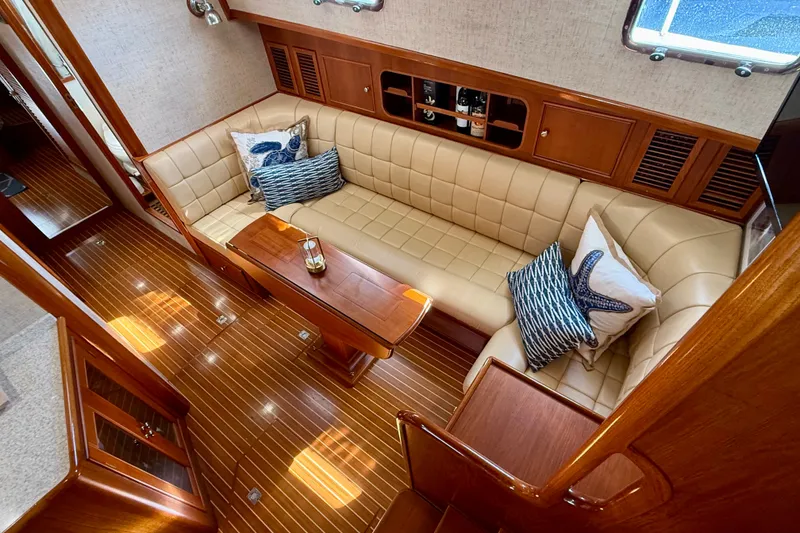Slide: The Image of Luxurious interior of 2003 Grand Banks 49 Eastbay HX yacht with elegant seating and wooden finishes. - 49