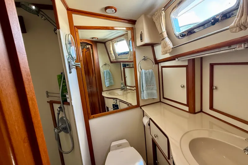 Slide: The Image of Luxurious 2003 Grand Banks 49 Eastbay HX yacht bathroom with wood accents and porthole window. - 68