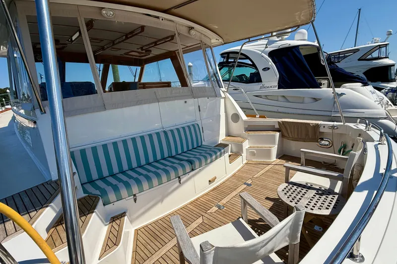 Slide: The Image of 2003 Grand Banks 49 Eastbay HX yacht with spacious deck and striped seating. - 30