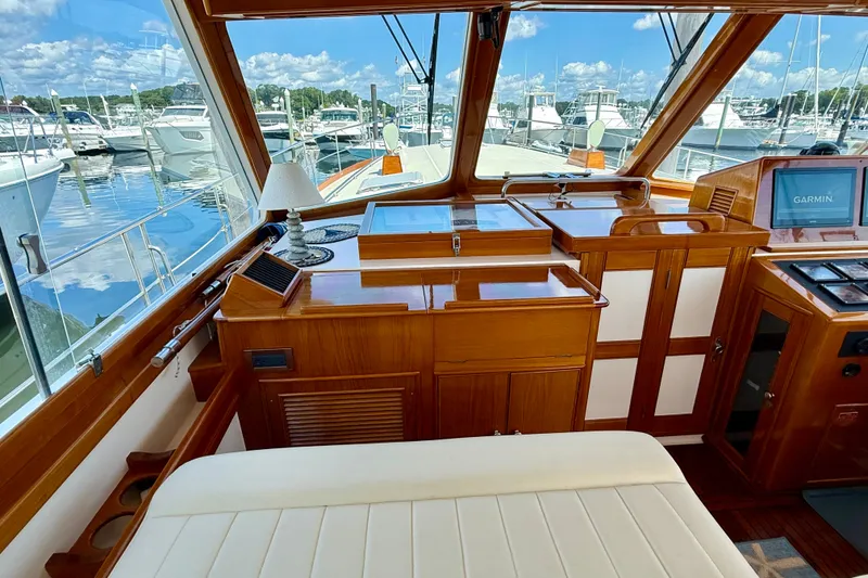 Slide: The Image of Luxurious 2003 Grand Banks 49 Eastbay HX yacht interior with wooden cabinetry and marina view. - 45