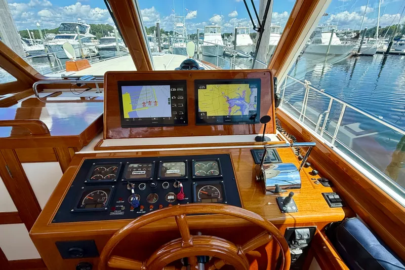 Slide: The Image of Helm of 2003 Grand Banks 49 Eastbay HX with navigation screens and controls. - 47