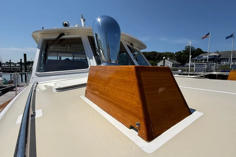 Slide: The Image of 2003 Grand Banks 49 Eastbay HX yacht with polished wood and chrome details at a marina. - 19