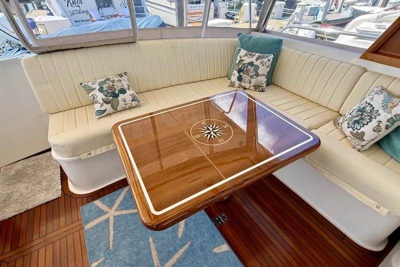 Slide: The Image of Luxurious 2003 Grand Banks 49 Eastbay HX yacht interior with elegant seating and wooden table. - 44