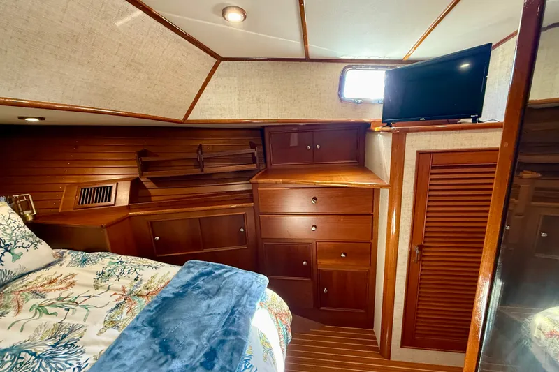 Slide: The Image of Luxurious cabin interior of 2003 Grand Banks 49 Eastbay HX yacht with wood finish and TV. - 64