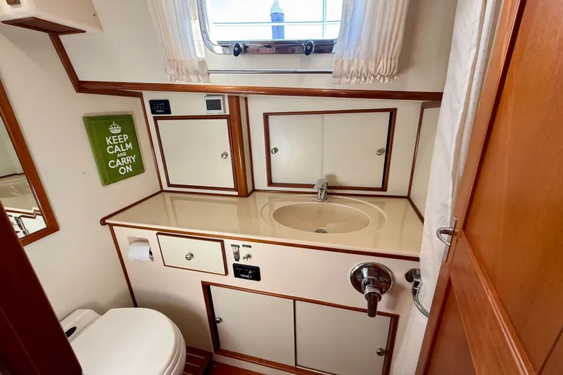 Slide: The Image of Bathroom interior of 2003 Grand Banks 49 Eastbay HX yacht, featuring sink and toilet. - 57
