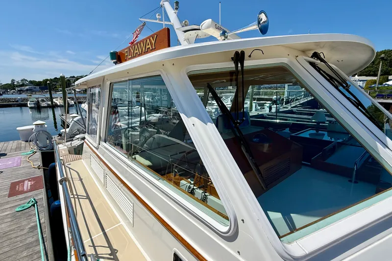 Slide: The Image of 2003 Grand Banks 49 Eastbay HX yacht docked at marina under clear blue sky. - 27