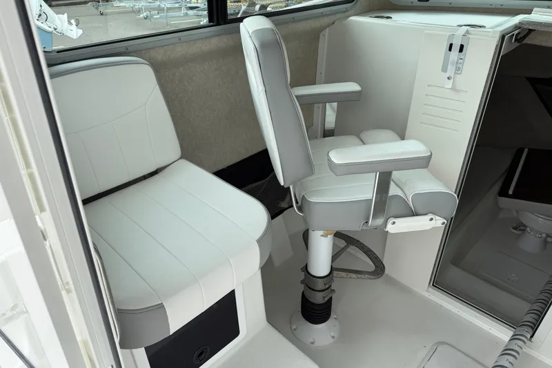 Slide: The Image of Interior of 2025 Parker 2520 XLD Sport Cabin, featuring seating and helm area. - 14