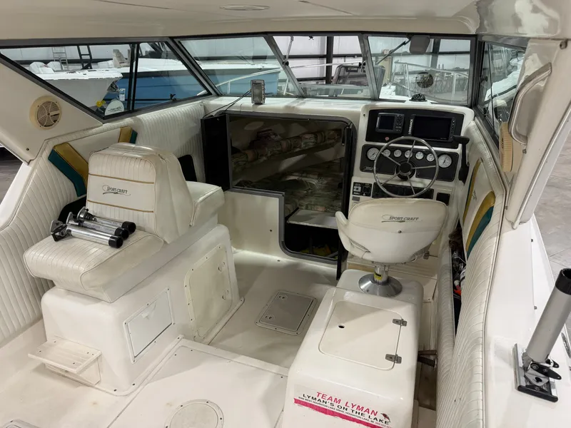 Slide: The Image of The image shows the cockpit of a 1999 Sport-Craft Sportsman with white seats and a steering console. - 16